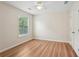 Bedroom featuring beautiful hardwood floors, a window letting in natural light, and a ceiling fan at 153 Towey Trl, Woodstock, GA 30188