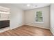 Bright bedroom featuring hardwood floors and a window offering a view of the outdoors at 153 Towey Trl, Woodstock, GA 30188
