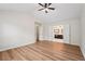 This bedroom features gorgeous hard wood floors, a ceiling fan, and double doors to the bathroom at 153 Towey Trl, Woodstock, GA 30188