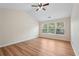 Spacious bedroom featuring vaulted ceilings, hardwood floors, and plenty of natural light from three windows at 153 Towey Trl, Woodstock, GA 30188