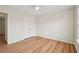 Cozy bedroom with hardwood floors, ceiling fan, and a closet off to the side at 153 Towey Trl, Woodstock, GA 30188