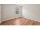 Bedroom featuring beautiful hardwood floors and a window that lets in tons of natural light at 153 Towey Trl, Woodstock, GA 30188