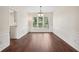 Bright dining room with hardwood floors and large windows at 153 Towey Trl, Woodstock, GA 30188