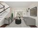 Bright, open-concept living room boasts hardwood floors and stylish gray furnishings at 153 Towey Trl, Woodstock, GA 30188