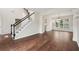 Bright living area features hardwood floors and a staircase at 153 Towey Trl, Woodstock, GA 30188