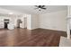 Open-concept living room showcasing hardwood floors and seamless flow to the modern kitchen at 153 Towey Trl, Woodstock, GA 30188