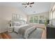Serene main bedroom with vaulted ceilings, large windows, and neutral decor at 153 Towey Trl, Woodstock, GA 30188