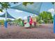 Community playground with shade covers, slides, climbing structures, and soft landing for to enjoy at 153 Towey Trl, Woodstock, GA 30188