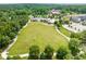 Expansive community green space featuring walking trails and recreational areas, surrounded by lush trees and neighborhood amenities at 240 Flowers Cove Ln, Lilburn, GA 30047