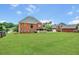 Expansive backyard with lush green lawn and mature trees, ideal for recreation and relaxation at 240 Flowers Cove Ln, Lilburn, GA 30047