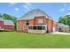 Large backyard with mature trees, perfect for outdoor activities, including a screened-in porch at 240 Flowers Cove Ln, Lilburn, GA 30047
