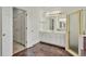 Bathroom featuring double doors, a vanity with marble countertops, and a glass-enclosed shower at 240 Flowers Cove Ln, Lilburn, GA 30047