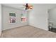 Bedroom with carpet, two windows, and a colorful ceiling fan at 240 Flowers Cove Ln, Lilburn, GA 30047