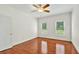 A bedroom featuring hardwood floors, a ceiling fan, and natural light from two windows at 240 Flowers Cove Ln, Lilburn, GA 30047