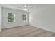 Bright bedroom with carpeted floors features two windows and plenty of open space at 240 Flowers Cove Ln, Lilburn, GA 30047