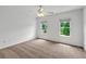 Bright bedroom featuring carpet floors, natural light, and views of the outdoors at 240 Flowers Cove Ln, Lilburn, GA 30047