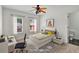 Bright bedroom with a colorful ceiling fan, cheerful decor, and a modern work space at 240 Flowers Cove Ln, Lilburn, GA 30047