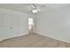 Neutral bedroom with carpet, ceiling fan, closet with double doors and open hallway at 240 Flowers Cove Ln, Lilburn, GA 30047