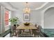 Staged dining room features a chandelier and views of the yard at 240 Flowers Cove Ln, Lilburn, GA 30047