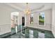 Bright dining room featuring a chandelier, large windows, and decorative molding, creating an elegant and inviting atmosphere at 240 Flowers Cove Ln, Lilburn, GA 30047