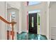 Bright foyer features gleaming tile floors, a decorative door, and views to a wood staircase at 240 Flowers Cove Ln, Lilburn, GA 30047