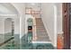 Elegant foyer featuring marble floors, a staircase, and an open view into the dining room, creating a grand entrance at 240 Flowers Cove Ln, Lilburn, GA 30047