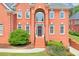 Elegant brick home featuring a stately entrance with a beautiful front door and manicured landscaping at 240 Flowers Cove Ln, Lilburn, GA 30047