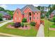 Beautiful brick home featuring lush landscaping, a well-maintained lawn, and a welcoming entrance at 240 Flowers Cove Ln, Lilburn, GA 30047