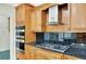 Close-up of stainless steel appliances and black granite countertops at 240 Flowers Cove Ln, Lilburn, GA 30047