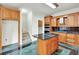 Modern kitchen featuring an island, black countertops, and stainless steel appliances at 240 Flowers Cove Ln, Lilburn, GA 30047