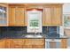 Kitchen showcasing stainless steel appliances, black countertops, and custom wooden cabinetry at 240 Flowers Cove Ln, Lilburn, GA 30047