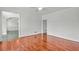 Hardwood floors highlight this living room, offering an open view to the dining room and plenty of light from the nearby windows at 240 Flowers Cove Ln, Lilburn, GA 30047
