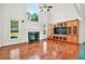 Spacious living room features hardwood floors, a cozy fireplace, and a custom built-in entertainment center with ample storage at 240 Flowers Cove Ln, Lilburn, GA 30047