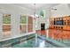 Open living space with large windows, a fireplace, and custom cabinetry for entertainment at 240 Flowers Cove Ln, Lilburn, GA 30047