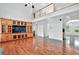 Bright living room featuring hardwood floors, built-in cabinetry, and a view of the home's second story at 240 Flowers Cove Ln, Lilburn, GA 30047
