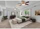 Spacious main bedroom featuring a ceiling fan, tray ceiling, and lots of natural light at 240 Flowers Cove Ln, Lilburn, GA 30047
