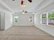 Main bedroom with tray ceiling and windows providing natural light at 240 Flowers Cove Ln, Lilburn, GA 30047