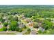 Aerial view of a suburban neighborhood featuring mature trees and well-maintained homes at 240 Flowers Cove Ln, Lilburn, GA 30047