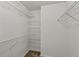 Walk-in closet featuring wire shelving for optimal storage and organization at 240 Flowers Cove Ln, Lilburn, GA 30047