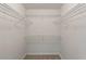 Bright walk-in closet with carpeted floors, ample wire shelving, and plenty of storage space at 240 Flowers Cove Ln, Lilburn, GA 30047