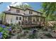 Beautiful backyard with deck, lush landscaping, and serene outdoor seating area surrounded by nature at 2819 Saddlebrook Nw Way, Marietta, GA 30064