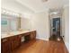 Bathroom featuring double vanities, cherry cabinets, and hardwood floors at 2819 Saddlebrook Nw Way, Marietta, GA 30064