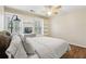Comfortable bedroom featuring a built-in desk and shelving, with a ceiling fan and large windows at 2819 Saddlebrook Nw Way, Marietta, GA 30064