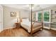 Cozy bedroom with hardwood floors, large window overlooking the yard, and built-in shelving at 2819 Saddlebrook Nw Way, Marietta, GA 30064