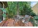 Wooden deck with seating, plants, and serene views of the lush, wooded backyard at 2819 Saddlebrook Nw Way, Marietta, GA 30064