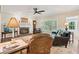 Inviting living room with cozy fireplace, plush seating, and natural light from large window at 2819 Saddlebrook Nw Way, Marietta, GA 30064
