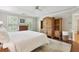Comfortable main bedroom with a tray ceiling, hardwood floors, and built-in storage at 2819 Saddlebrook Nw Way, Marietta, GA 30064