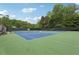 Community tennis courts with surrounding greenery and lighting at 2819 Saddlebrook Nw Way, Marietta, GA 30064
