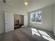 Bright bedroom featuring soft carpet, neutral walls, and great sunlight at 518 Healy Dr # 68, Cumming, GA 30040