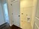 Neat laundry room boasts tile flooring and ample storage space at 518 Healy Dr # 68, Cumming, GA 30040